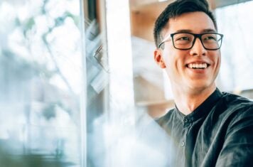 Man smiling at desk